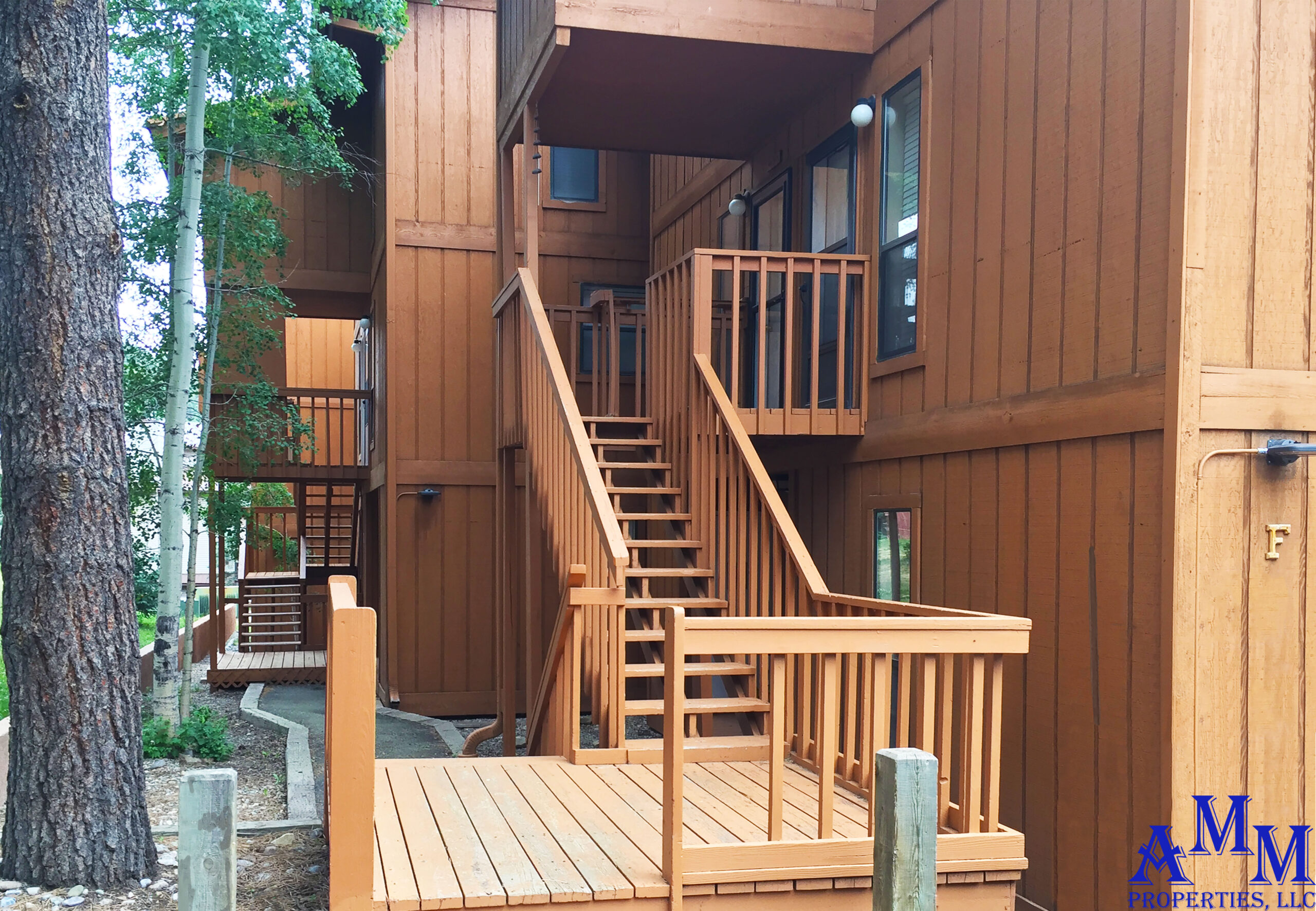 From the parking lot, there are two steps up, then four steps down to the front porch of the Cozy Mountain Condo.