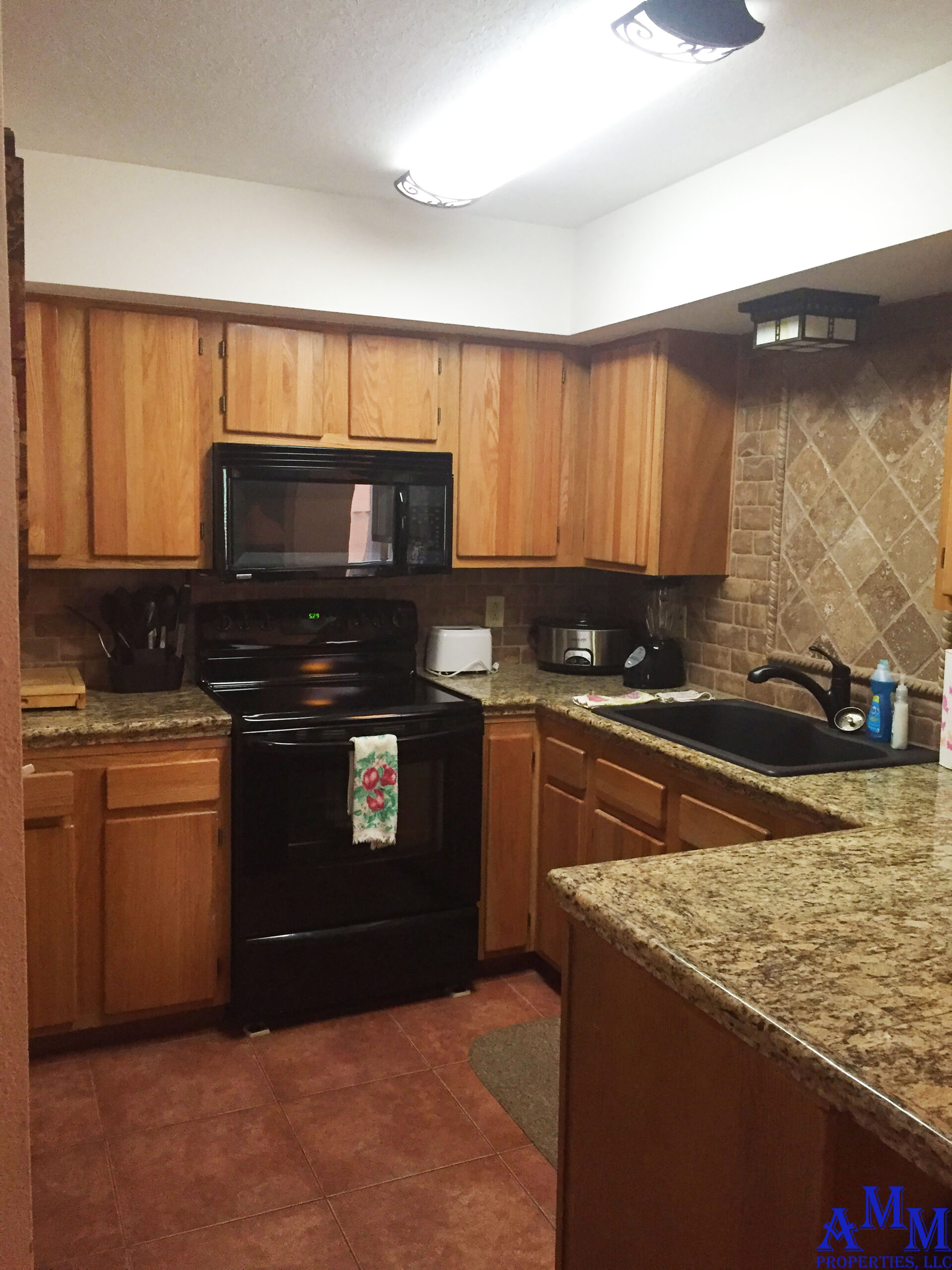 Full kitchen equipped with plenty of utensils, dishes, pots and pans, a crockpot and coffeemaker.