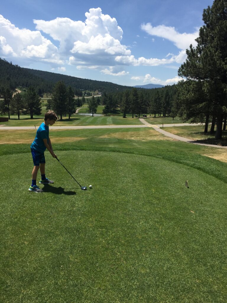 Young golfer getting ready to tee off at the Angel Fire Golf Course